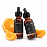 MÉLARE Vitamin C Serum Duo displayed with fresh orange slices