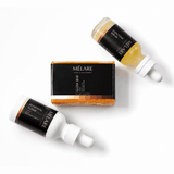 Mélare Glass Skin Effect product with a sleek bottle and clear labeling, designed to give a luminous, glass-like skin finish.