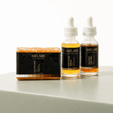Mélare Glass Skin Effect product showing a sleek bottle with clear, luminous glass skin effect formula for radiant complexion