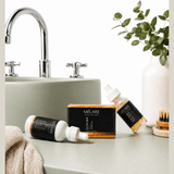 Mélare Glass Skin Effect product showing a sleek, clear bottle with a minimalist design and a smooth, glowing skin theme.