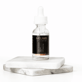 Mélare Dew Quench Serum in a 30ml bottle, facial care product with clear liquid, designed to hydrate and refresh skin.
