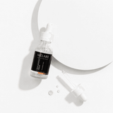 Mélare Dew Quench Serum in a 30ml bottle, facial care product with clear liquid and dropper applicator for hydration.
